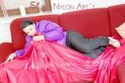 SEXY JILL lounging on the sofa wearing a sexy black shiny nylon rain pants and a purple shiny nylon down jacket (Pics)