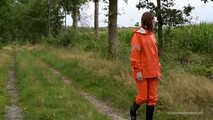 Miss Petra takes a walk in a orange AGU rain suit and rubber boots