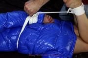 Simone tied and gagged in a shiny nylon downcoat