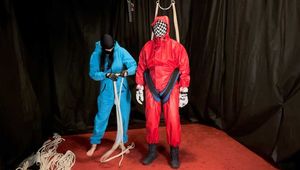 Sebastien breathplay in a red PVC jumpsuit.