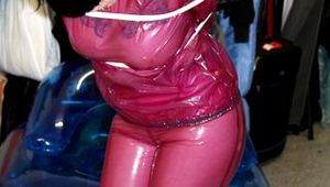 Jill tied and gagged in a semi-transparent purple PVC suit