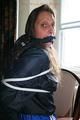 Stella tied and gagged on a chair wearing a blue shiny nylon shorts and a rain jacket (Pics)