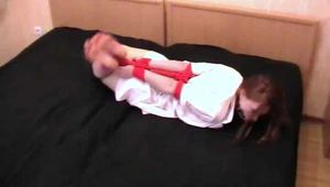 Barefoot nurse Gatitta tied up with a red rope (video)
