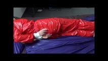 Samantha tied and gagged on bed wearing a shiny red sauna suit (Video)