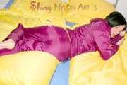 ENNI wearing a sexy purple shiny nylon rain suit lying in bed with yellow shiny nylon cloths lolling and posing (Pics)