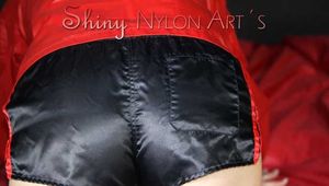 Watching sexy SONJA wearing a sexy black shiny nylon shorts and a red rainjacket preparing her lolling area (Pics)