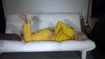 Watching Pia preparing her sofa with a shiny nylon cloth wearing a yellow shiny nylon rainsuit enjoying herslef on the sofa (Video)