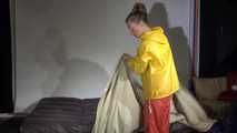 Watching sexy Sandra wearing different shiny nylon rainwear and preparing bed  (Video)