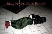 Jill tied, gagged and hooded on a cellar floor wearing a shiny green rain pants and a shiny black down jacket (Pics)