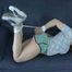 Katharina tied and gagged on a sofa wearing old school shiny nylon shorts (Video)