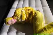 Get Pictures of Pia bound and gagged in her yellow shiny nylon Rainwear