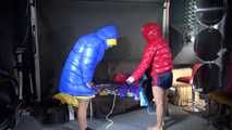 Watching sexy Stella and Sandra wearing a sexy shiny nylon shorts putting on several shiny nylon down jackets (Video)