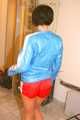 SEXY ENNI wearing a hot red shiny nylon shorts and a lightblue shiny nylon rain jacket during ironing the shirt of her boyfriend (Pics)