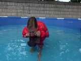 Watch Sandra enjoying the Pool during a hot summer Day with her shiny nylon Downjacket