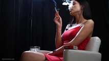 Sexy lady in red is smoking two 100mm reds