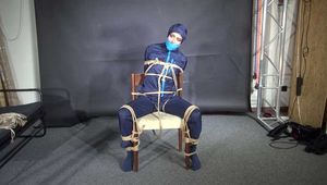 Marie bound and gagged in shiny nylon Rainwear