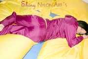 ENNI wearing a sexy purple shiny nylon rain suit lying in bed with yellow shiny nylon cloths lolling and posing (Pics)