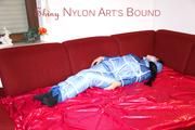 Lucy tied and gagged with a rope and a gag on a red sofa wearing an oldschool blue downwear combination (Pics)