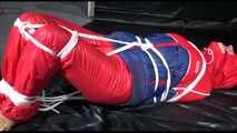 SANDRA tied, gagged and hooded on the floor wearing a supersexy oldschool red/blue down suit (Video)