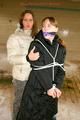 Blond-haired archive girl tied and gagged by another archive girl wearing shiny down jackets (Pics)