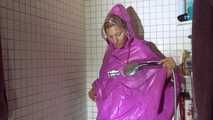 Watching Sandra wearing only a pink shiny nylon raincape under the shower playing with the water (Video)