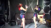 Watching sexy Stella and Sandra both wearing a hot shiny nylon shorts and a top being tied and gagged overhead with ropes and a ballgag (Video)