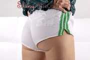 Watching our sexy archive girl wearing a sexy white shiny nylon shorts and a green rainjacket (Pics)