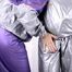 Sophie tied and gagged by Jill on a sofa wearing a shiny silver PVC sauna suit which is slitted by Jill (Pics)
