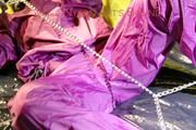 Sonja ties, gagges and hoodes herself with hand cuffs on a bed wearing a supersexy purple rainnwear (Pics)