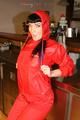 Jill posing in a bar wearing a sexy red rainwear combination with nothing under it (Pics)