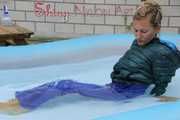 Watching Sandra wearing a sexy blue shiny nylon rainwear bib and a green down jacket while taking a sunbath and a bath in the swimming pool  (Pics)