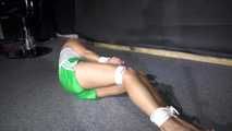 Sexy Sandra being tied and gagged on the floor wearing a sexy green shiny nylon shorts and a white top (Video)