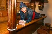 An archive girl tied and gagged on a bar wearing shiny nylon rainwear (Pics)