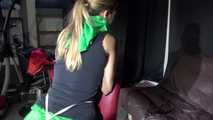 Watching sexy Sandra wearing a sexy green shiny nylon shorts and a black top being tied and gagged with ropes and a clothgag on a chair (Video)