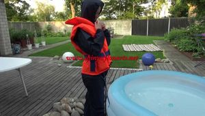 Sonja cools down in the swimming pool wearing sexy blue rainwear and a lifevest (Video)