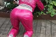 Watching Aiyana wearing supersexy pink shiny nylon rainwear while planting flowers in the garden (Pics)