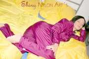 ENNI wearing a sexy purple shiny nylon rain suit lying in bed with yellow shiny nylon cloths lolling and posing (Pics)