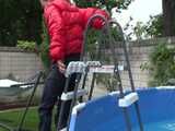 Watch Sandra enjoying the Pool during a hot summer Day with her shiny nylon Downjacket