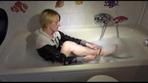 Sonja ties and gagges herself in a bath tub wearing a black shiny nylon shorts and a rain jacket (Video)