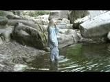 Sophie enjoying the water and weather on a river wearing supersexy grey rainwear (Video)