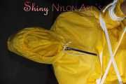 Sandra being tied and gagged on a hairdresser´s chair wearing sexy yellow shiny nylon rainwear being double hooded (Pics)