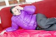 SEXY JILL lounging on the sofa wearing a sexy black shiny nylon rain pants and a purple shiny nylon down jacket (Pics)