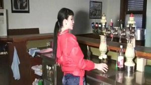 Jill in a bar wearing a sexy blue/red shiny nylon shorts and a red rain jacket (Video)