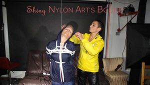 Sandra tied and gagged overhead with ropes and a ballgag overhead prepared to be hunged up by Stella both wearing sexy shiny nylon rainwear (Pics) PART1of 2