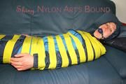 Katharina tied and gagged with tape on a sofa wearing shiny rainwear (Pics)