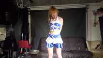 Red haired Woman bound and gagged in a shiny wetlook Cheerleader Dress