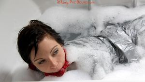 Simone in an shiny grey pvc sauna suit tied and gagged by Sophie in the bath tub (pics)