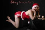 Mara wearing a sexy shiny nylon santa claus cloth posing in a studio (Pics)