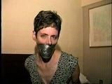 47 Yr OLD UNCOOPERATIVE BRAT LATINA HAIR DRESSER IS WRAP TAPE GAGGED, WIDE EYED GAG TALKING, BOUND UP WITH DUCT TAPE AND BAREFOOT (D59-11)