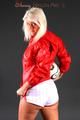 Sexy blonde-haired archive girl posing in a studio wearing a white shiny nylon shorts and a red rain jacket (Pics)